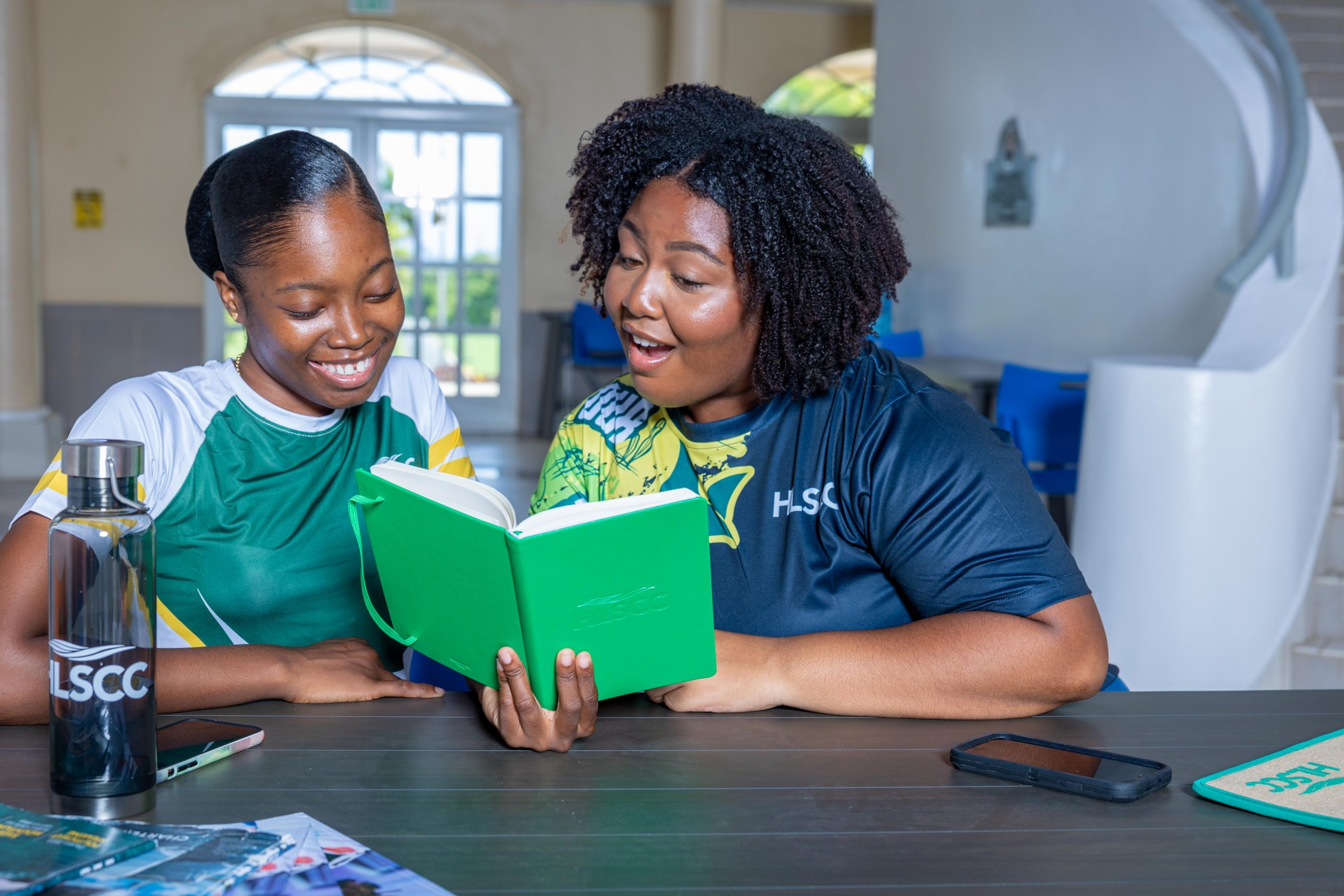 Students reading HLSCC notebook