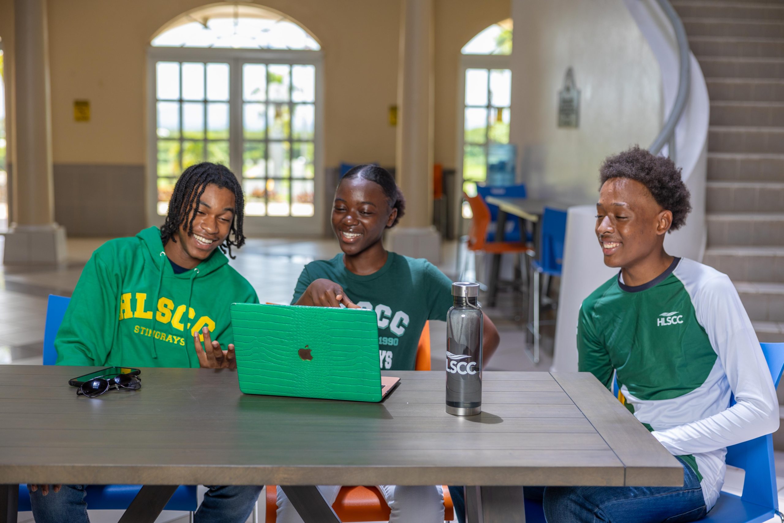 Students smiling with HLSCC campus items
