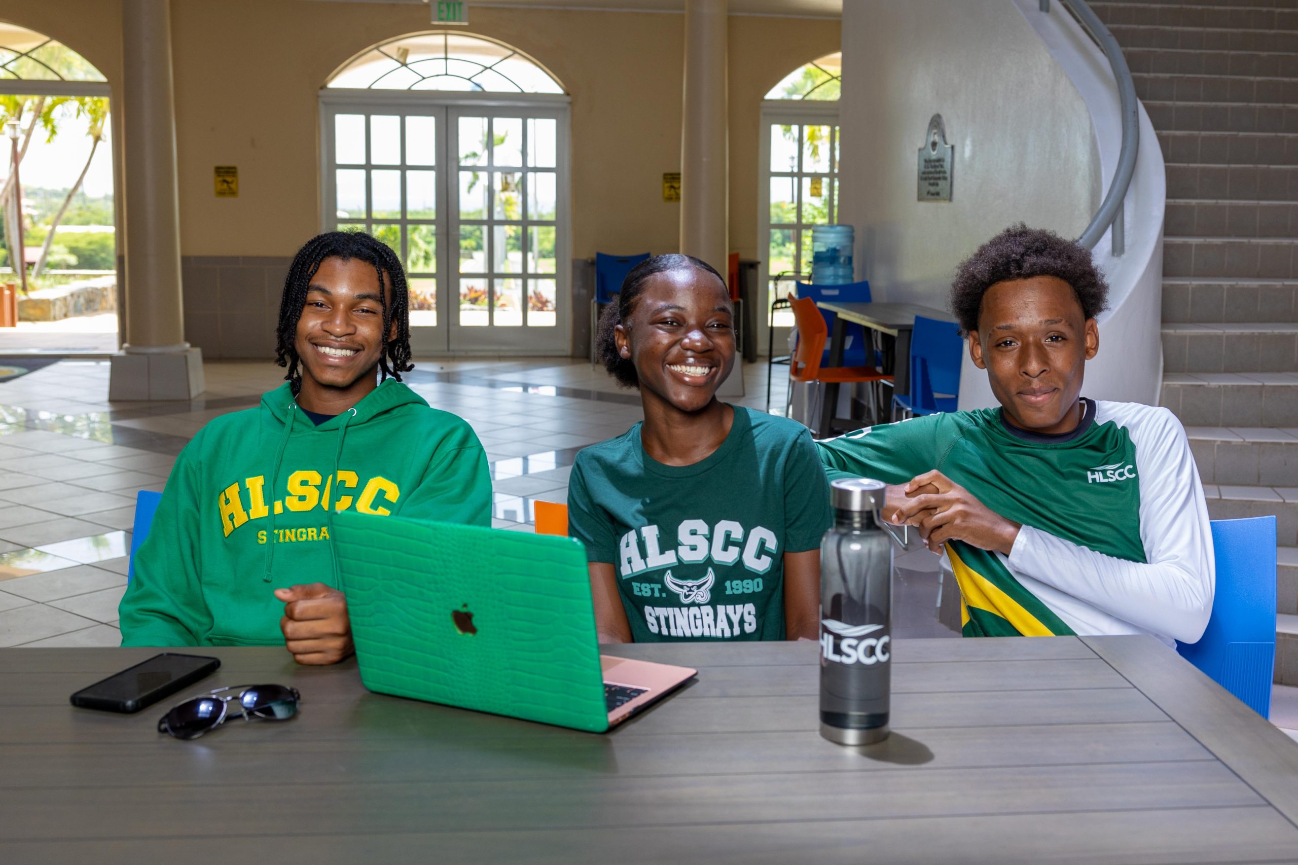 Students wearing HLSCC items at a campus table